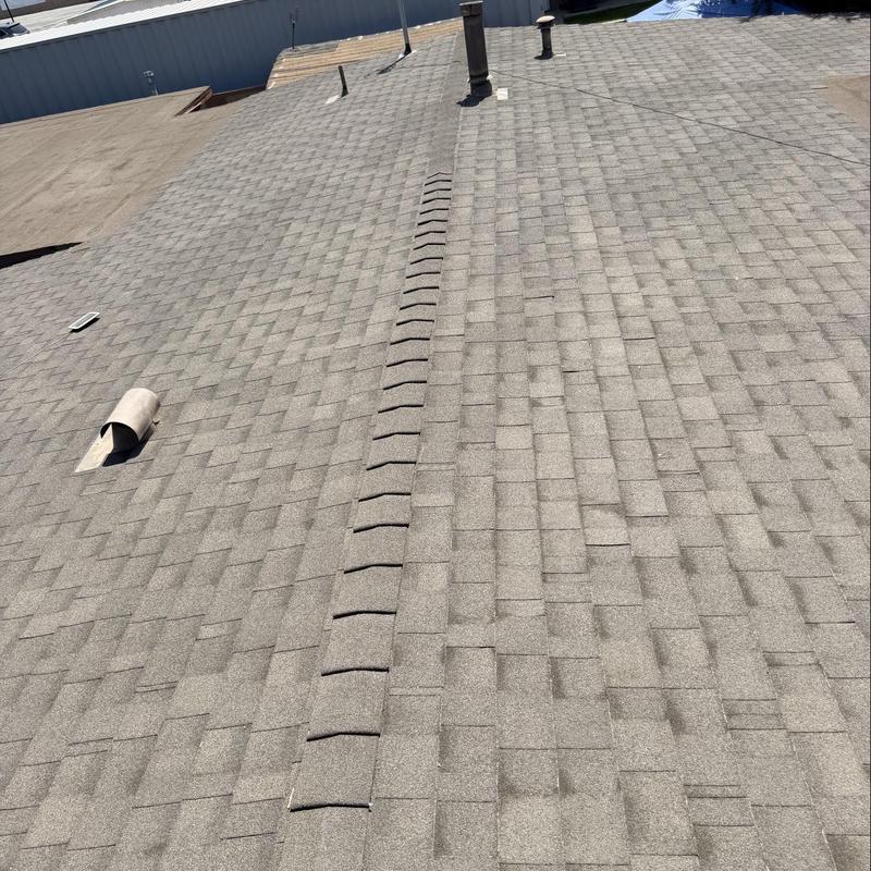 Shingle roof with ridge vent and roof pipes Shingle roof with ridge vent and roof pipes