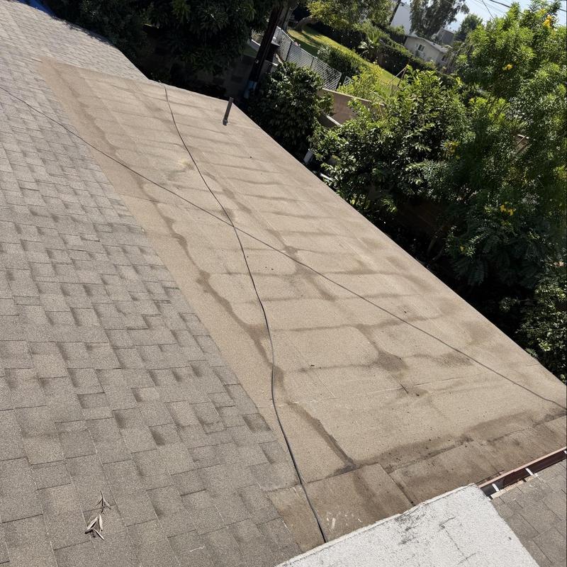 Shingles roof and flat roof surface showing wear and stains Shingles roof and flat roof surface showing wear and stains