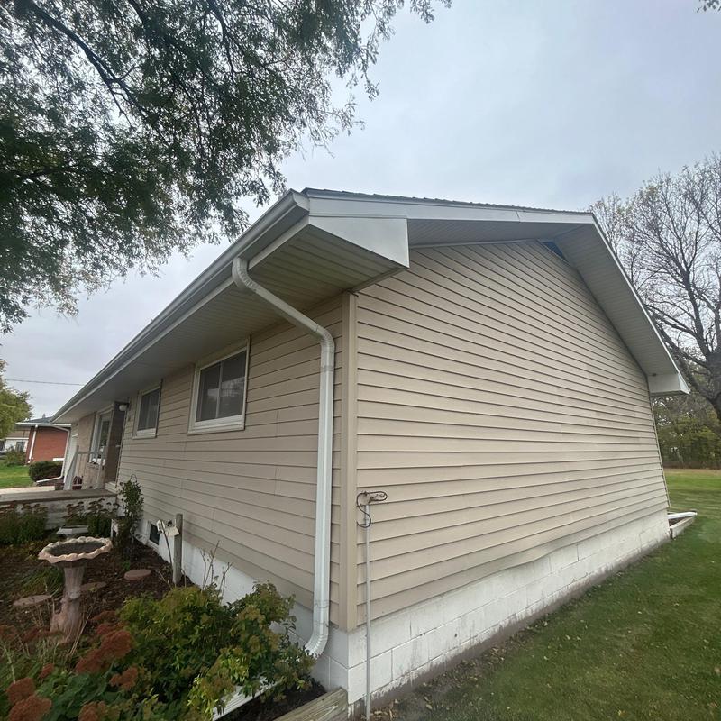 Aluminum gutters with downspout on house exterior Aluminum gutters with downspout on house exterior