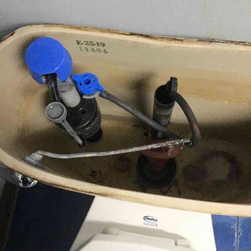 Toilet fill valve and flush valve assembly inside tank