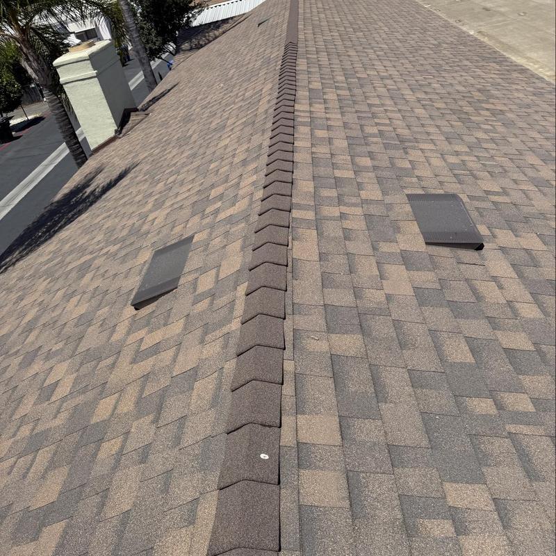 Shingle roof ridge with vents on residential home Shingle roof ridge with vents on residential home