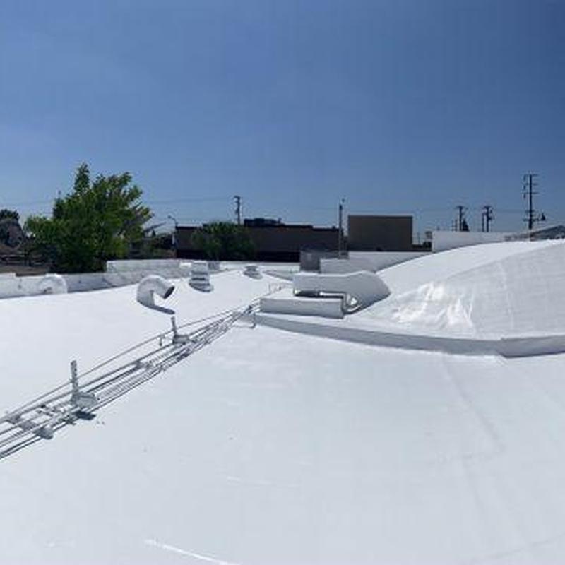 Commercial white TPO roofing system with vents and piping Commercial white TPO roofing system with vents and piping