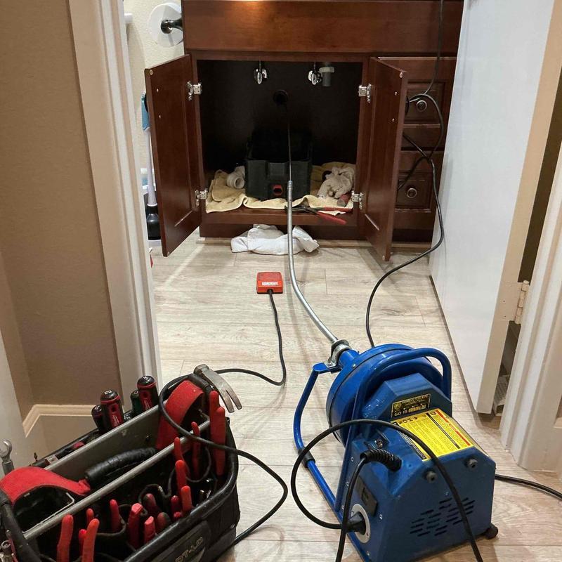 Drain line cable machine setup under bathroom sink