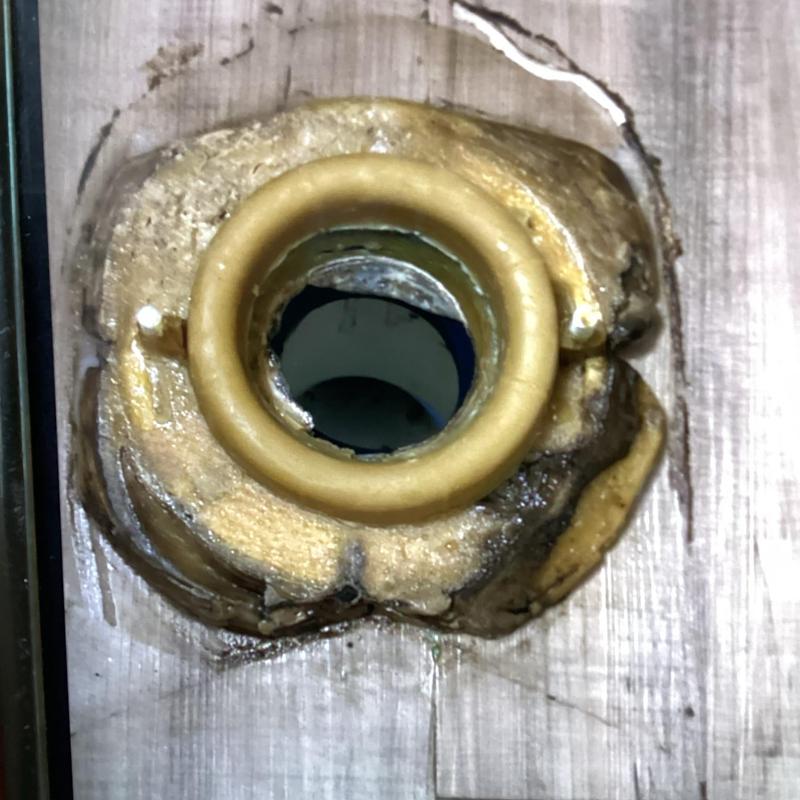 Toilet flange with wax ring seal on wooden floor Toilet flange with wax ring seal on wooden floor