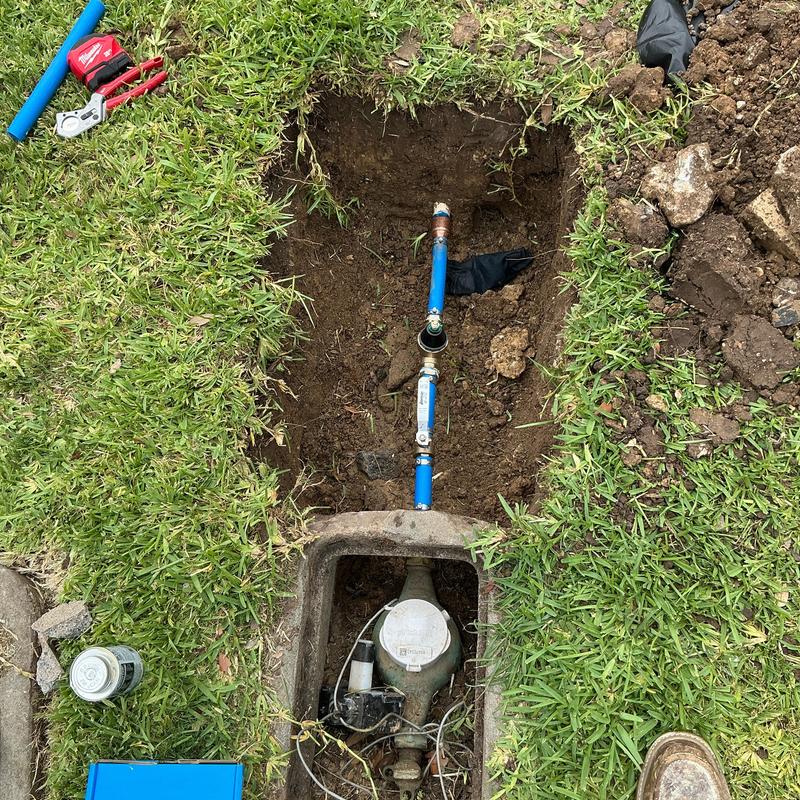 1in ball valve with blue pipes in ground trench