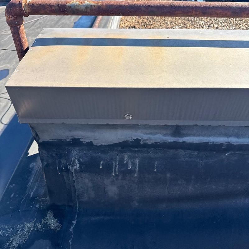 Commercial roof flashing showing weathering and rust stains