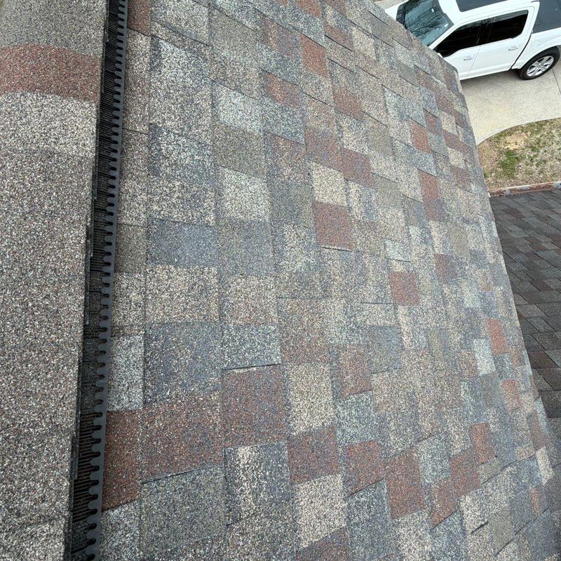 Asphalt shingle roof showing hail damage and wear