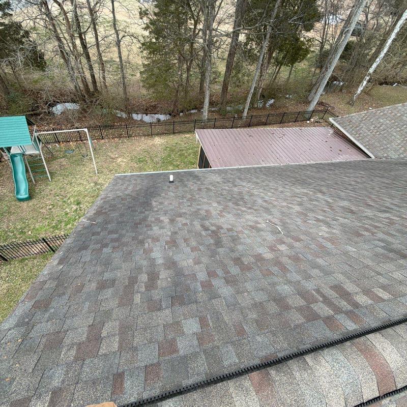 Asphalt shingle roof with visible hail damage and wear