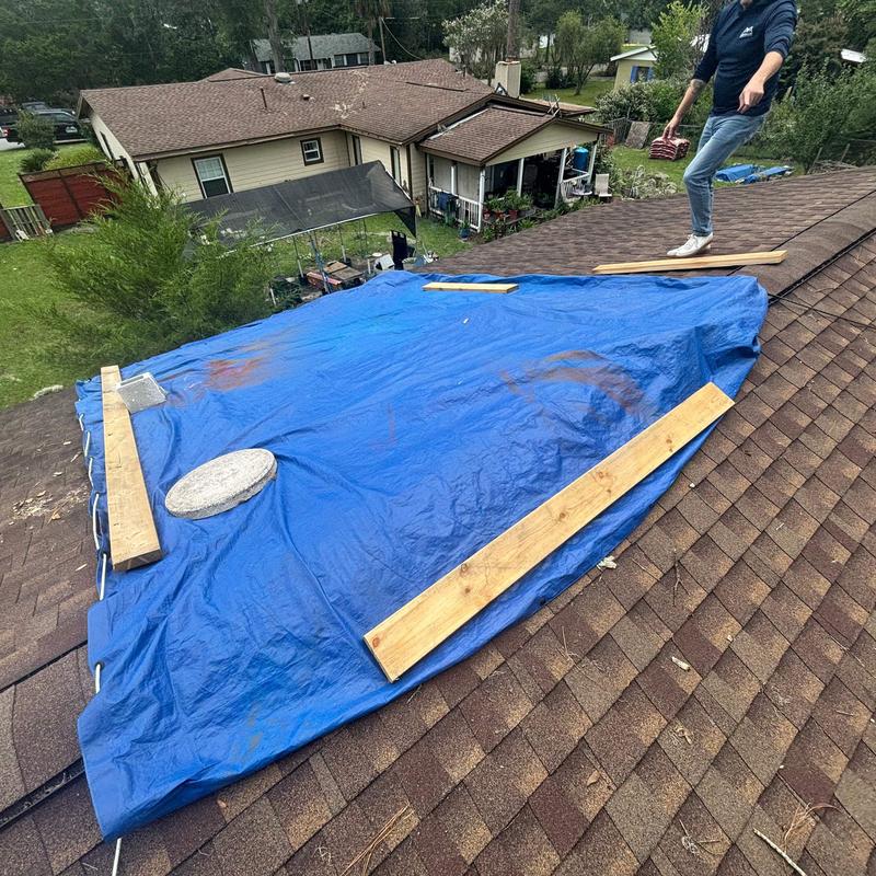 Roof tarping with wood planks after hail damage inspection
