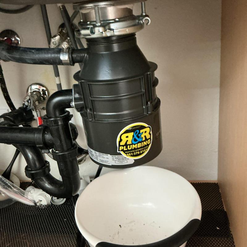 Garbage disposal unit installed under kitchen sink Garbage disposal unit installed under kitchen sink