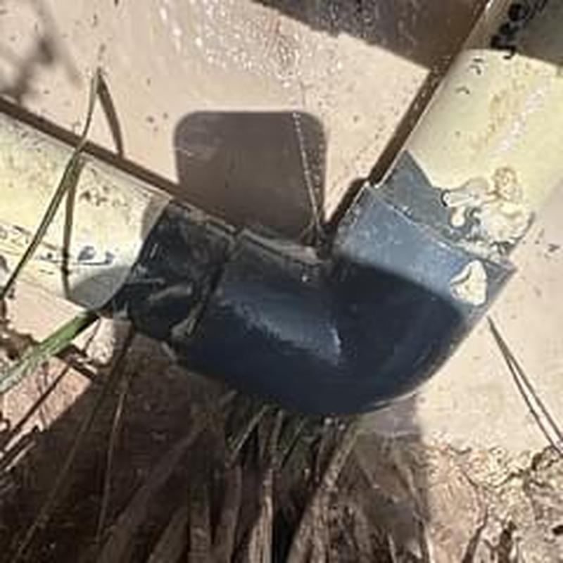 PVC water pipe repair with new elbow fitting outdoors PVC water pipe repair with new elbow fitting outdoors