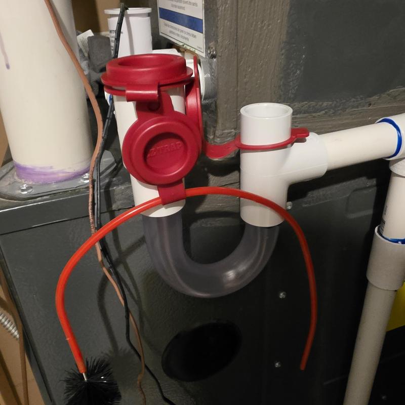 Indoor air conditioner drain trap with cleaning brush attached Indoor air conditioner drain trap with cleaning brush attached