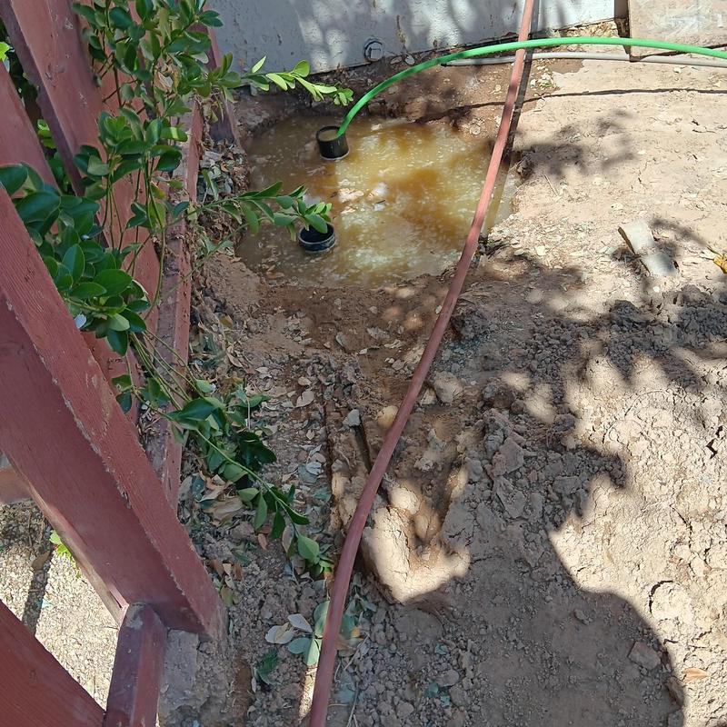 Broken sewer line spot repair with water flushing outdoors Broken sewer line spot repair with water flushing outdoors
