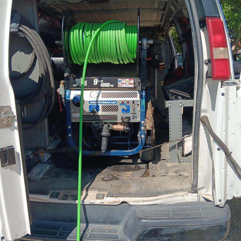 Sewer jetting machine with green hose in service van Sewer jetting machine with green hose in service van