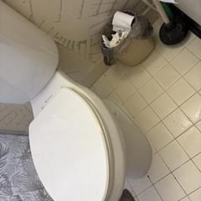 Toilet installation with wax ring and caulking in bathroom Toilet installation with wax ring and caulking in bathroom