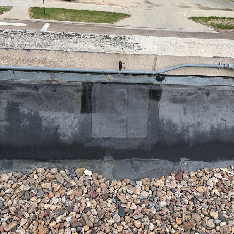 EPDM roof patch with gravel ballast and conduit above EPDM roof patch with gravel ballast and conduit above