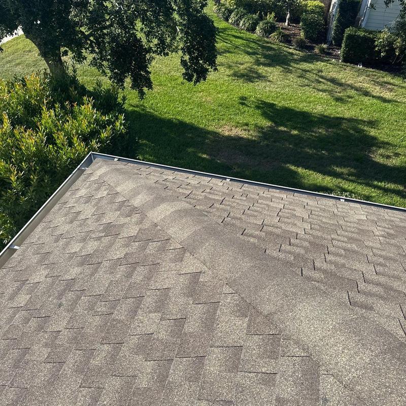 Roof shingles on residential house with lawn views Roof shingles on residential house with lawn views