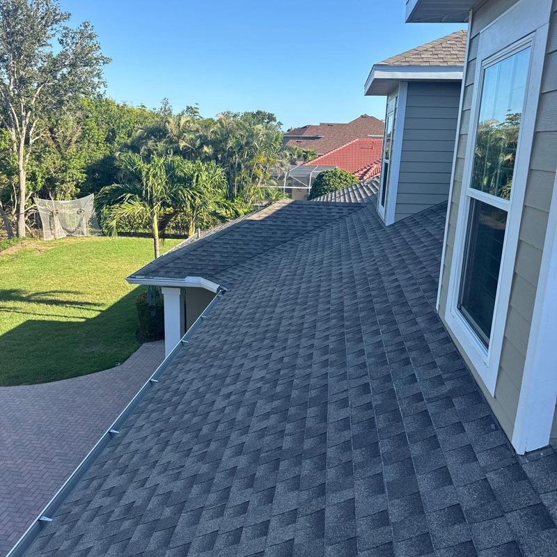 Asphalt shingle roof with replaced damaged sections Asphalt shingle roof with replaced damaged sections