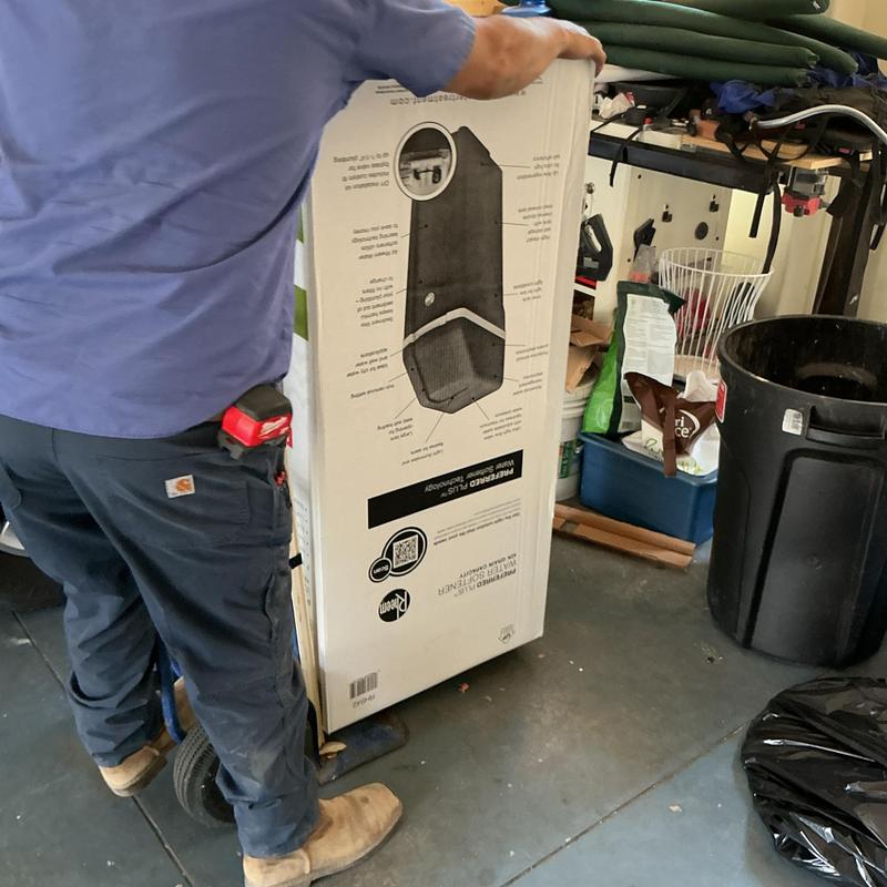 Water softener unit on hand truck in garage space