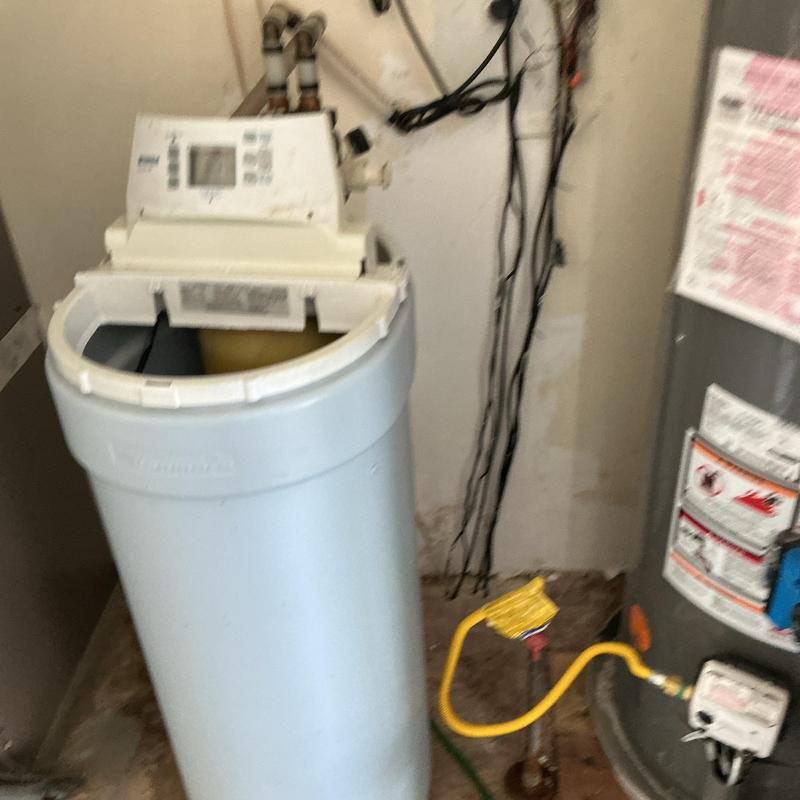Water softener system with control panel and plumbing connections