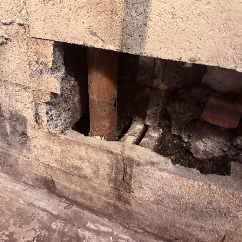 Cast-iron pipe exposed in concrete wall cavity Cast-iron pipe exposed in concrete wall cavity