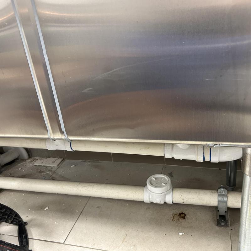 Grease interceptor plumbing and drainage pipes under sink