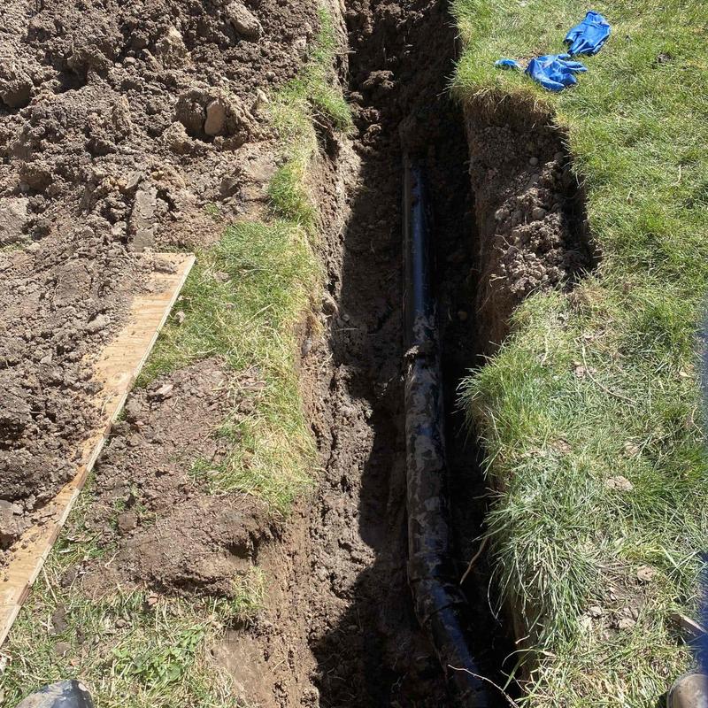 Sewer line exposed in trench for septic repair Sewer line exposed in trench for septic repair