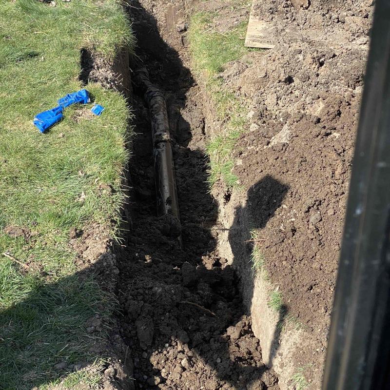 Sewer line exposed in trench for repair near septic tank Sewer line exposed in trench for repair near septic tank