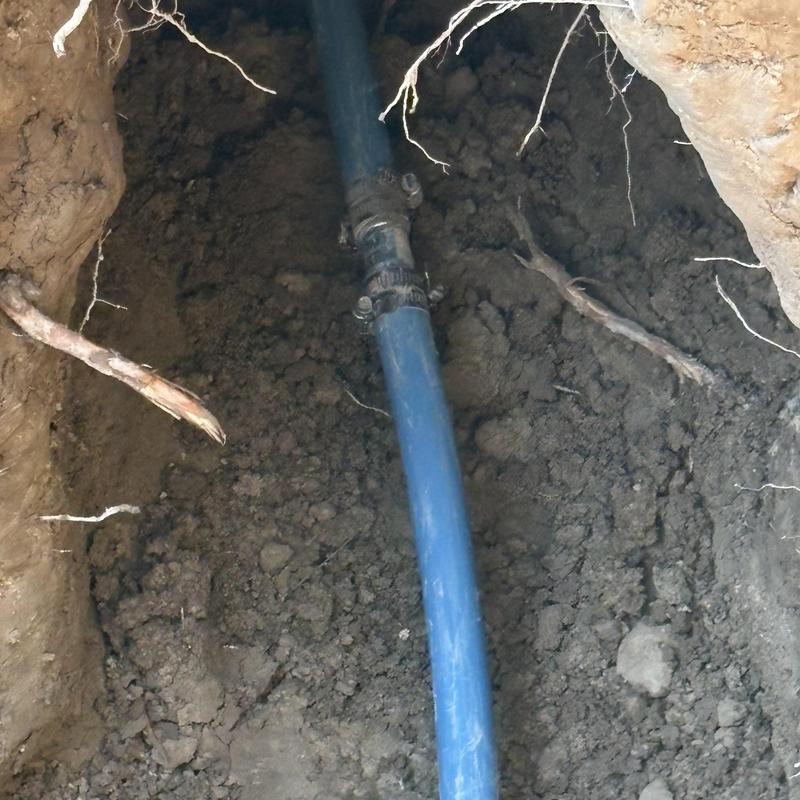 Water service line with couplings in trench