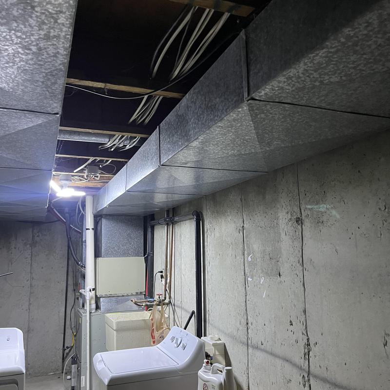 Sheet metal HVAC ductwork installation in basement