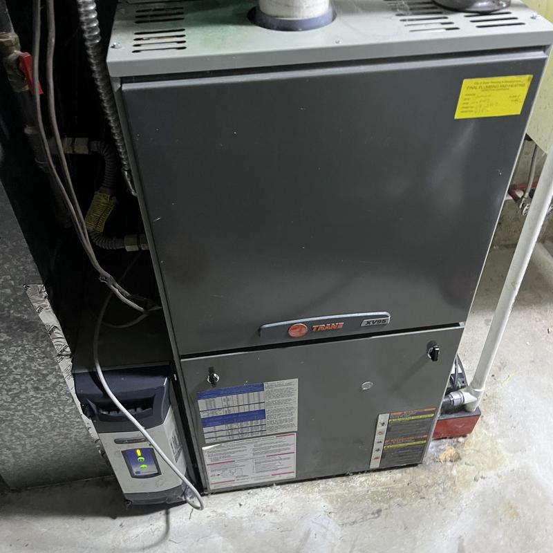 Furnace unit with control panel in basement setup