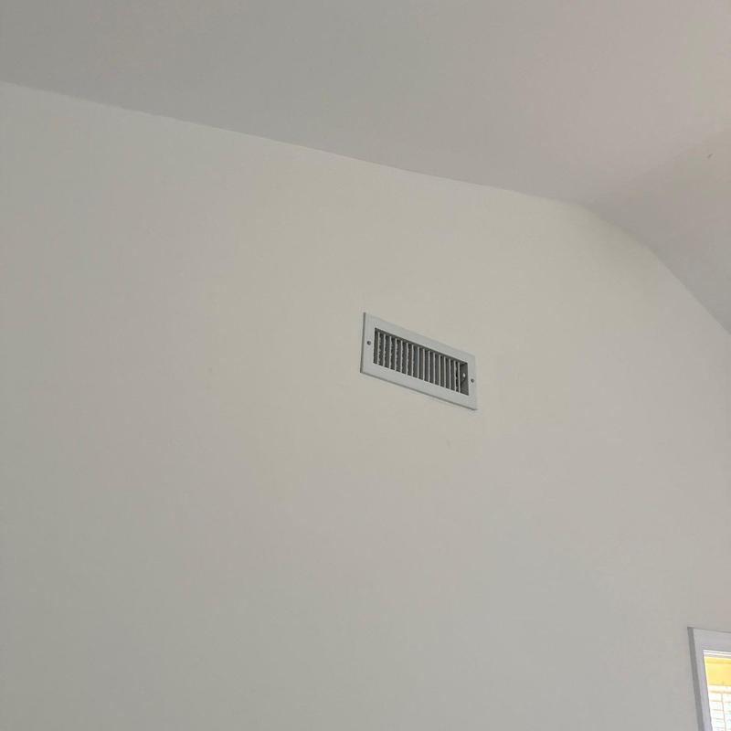 HVAC wall vent installed in white interior wall