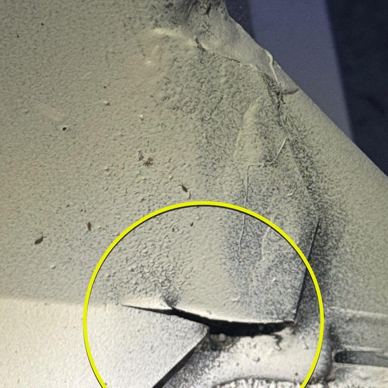 Metal roof flashing with visible crack damage