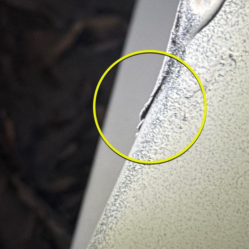 Metal flashing edge with hail damage close-up