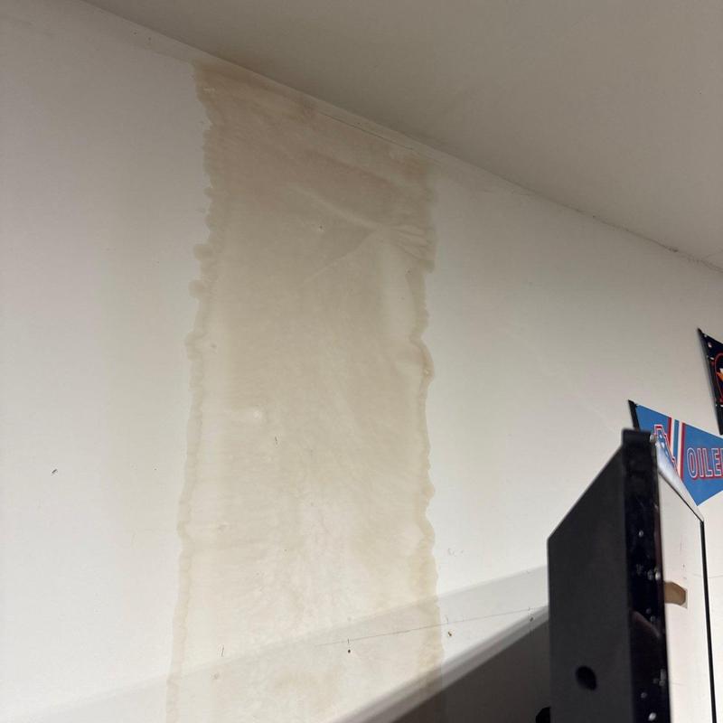 Drywall water stain on interior wall near ceiling