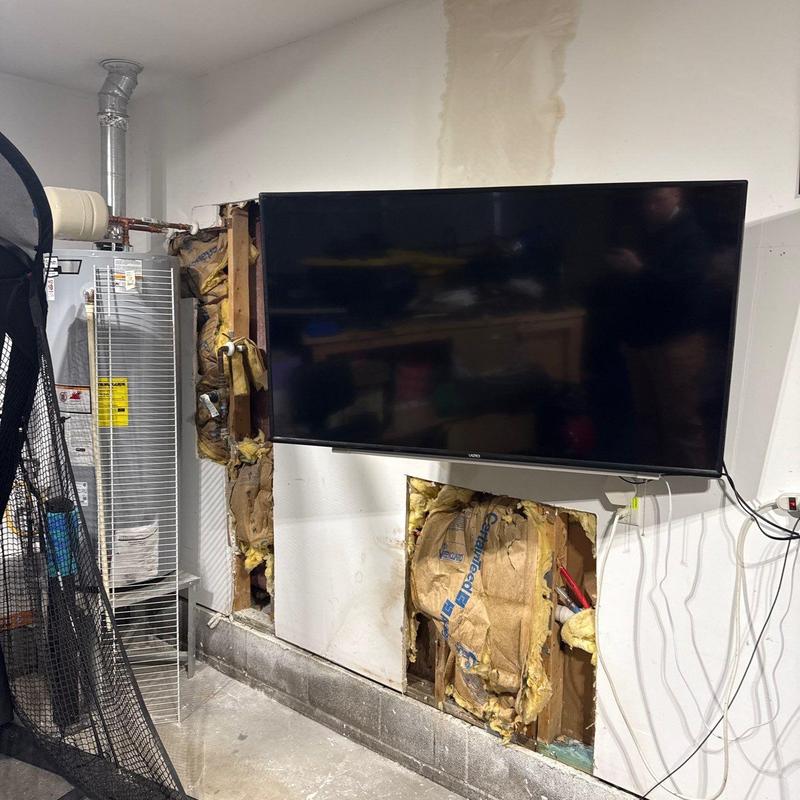 Water heater with exposed wall insulation and TV mount