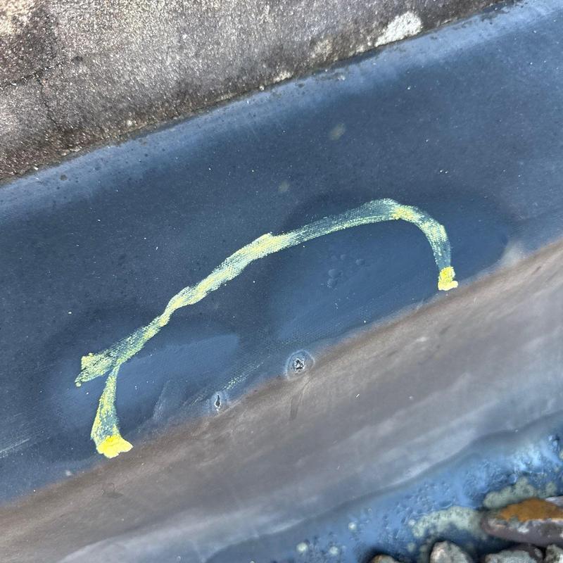 Commercial roof flashing with hail damage marks