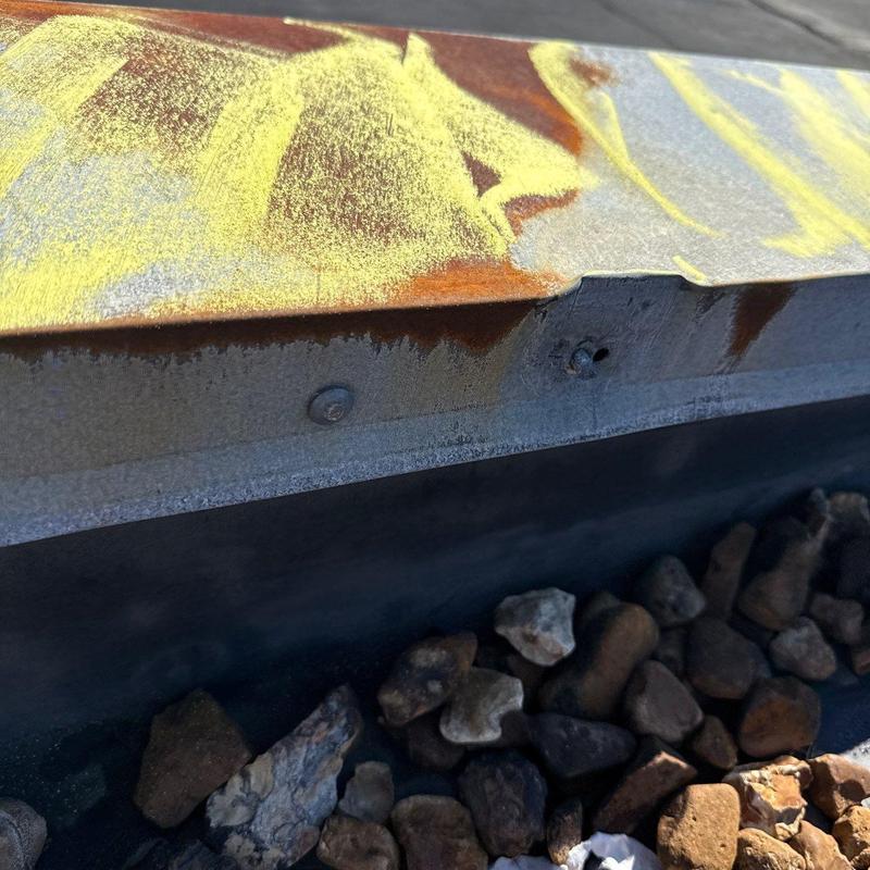 Metal roof flashing with hail damage and chalk markings