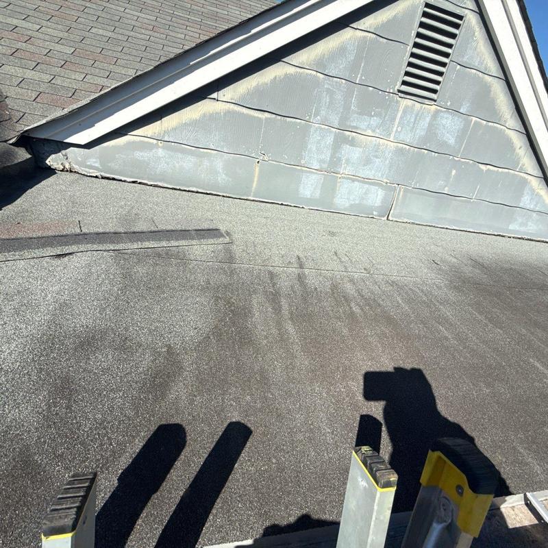 Flat roof surface with flashing and vent structure