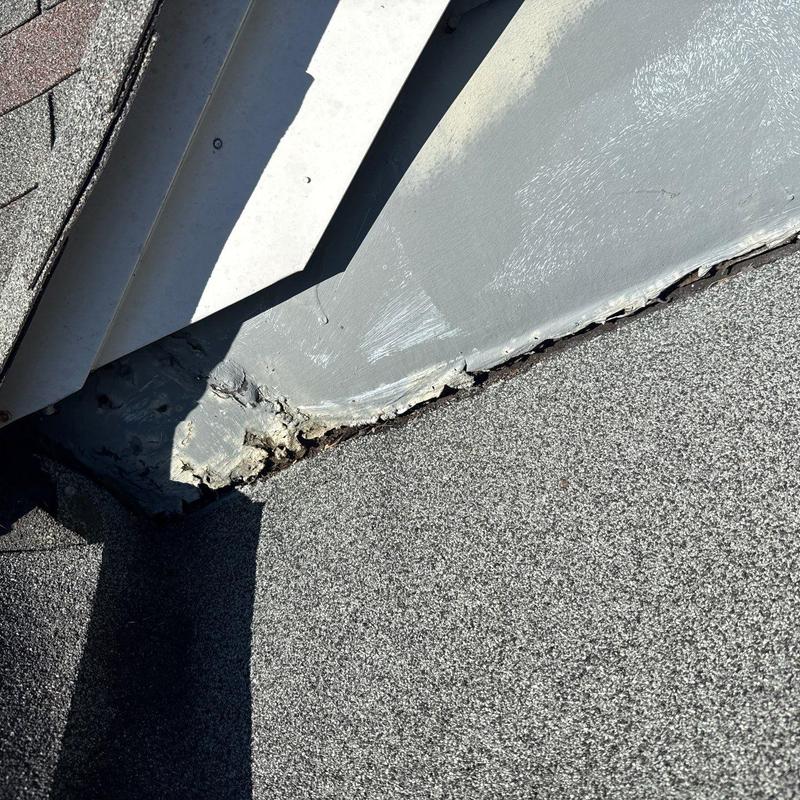 Roof flashing with hail damage and wear on shingles