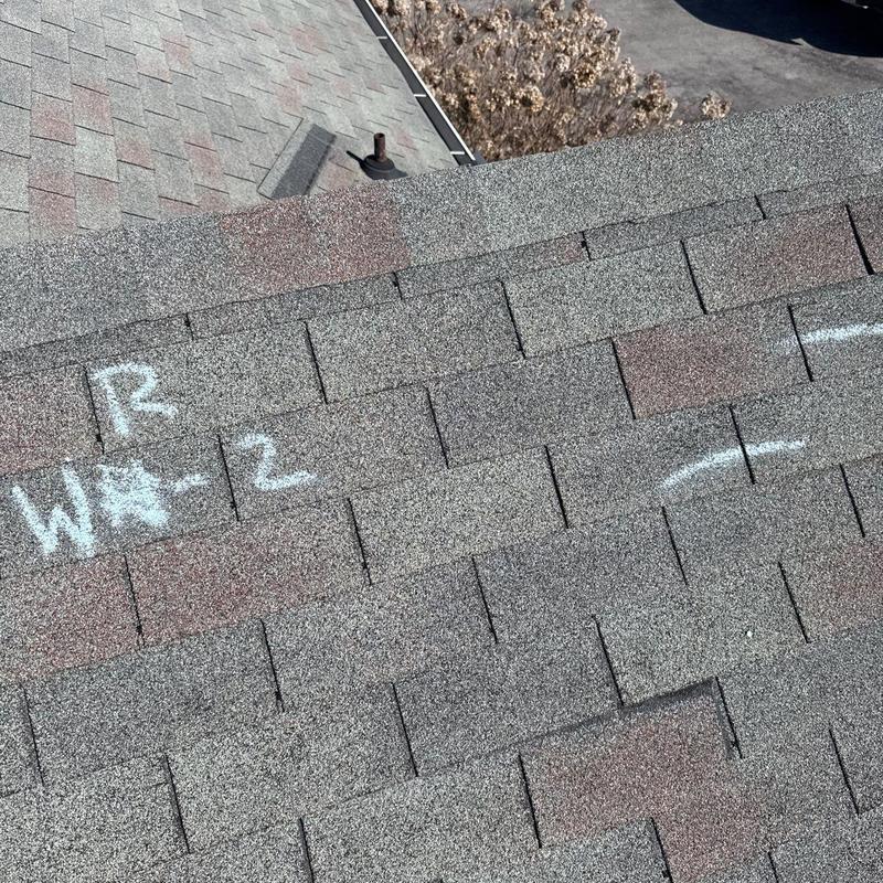 Roof shingles with chalk markings for hail damage inspection