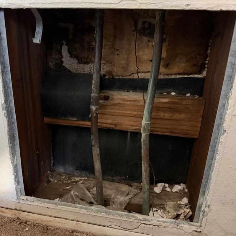 Copper hot-water pipe inside wall with drywall removed