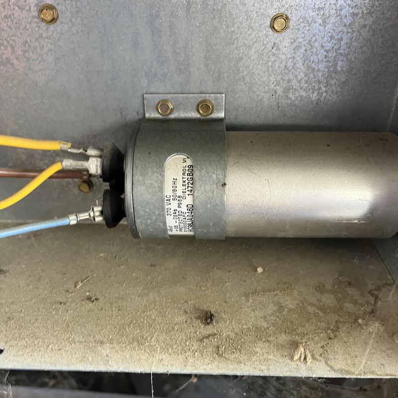 AC system capacitor with wiring connections installed AC system capacitor with wiring connections installed