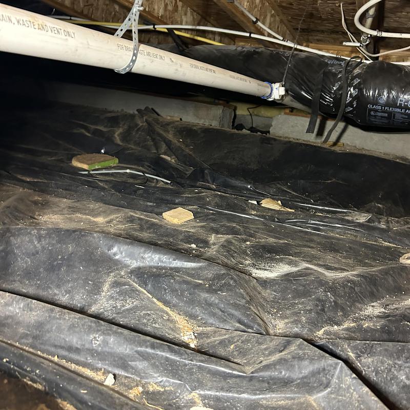 Crawl space vapor barrier with duct and plumbing pipes