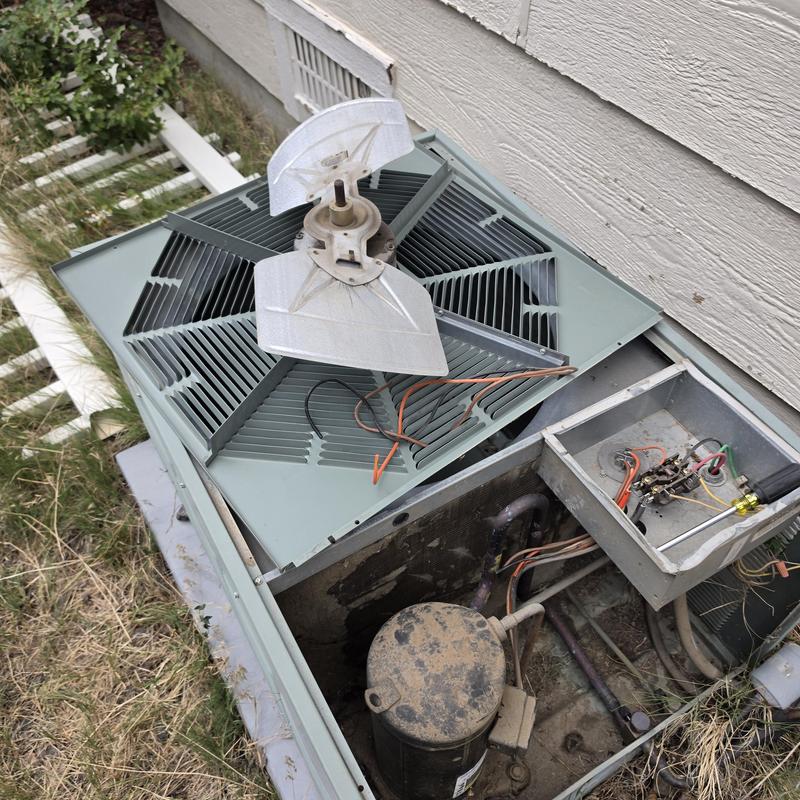 Condenser fan motor and coils on Rheem AC unit open Condenser fan motor and coils on Rheem AC unit open
