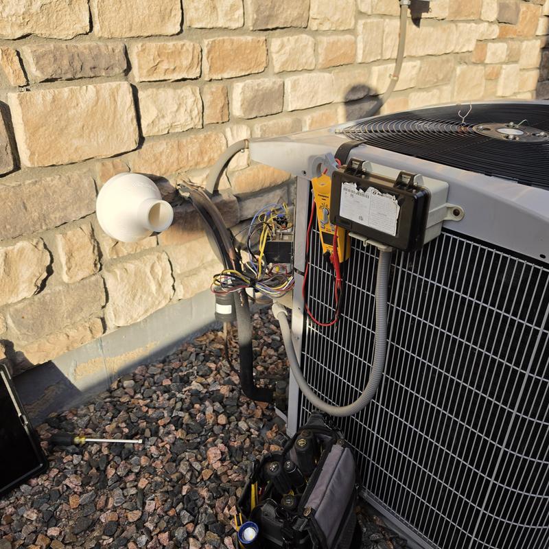 Carrier condenser fan motor with HVAC tools near unit Carrier condenser fan motor with HVAC tools near unit