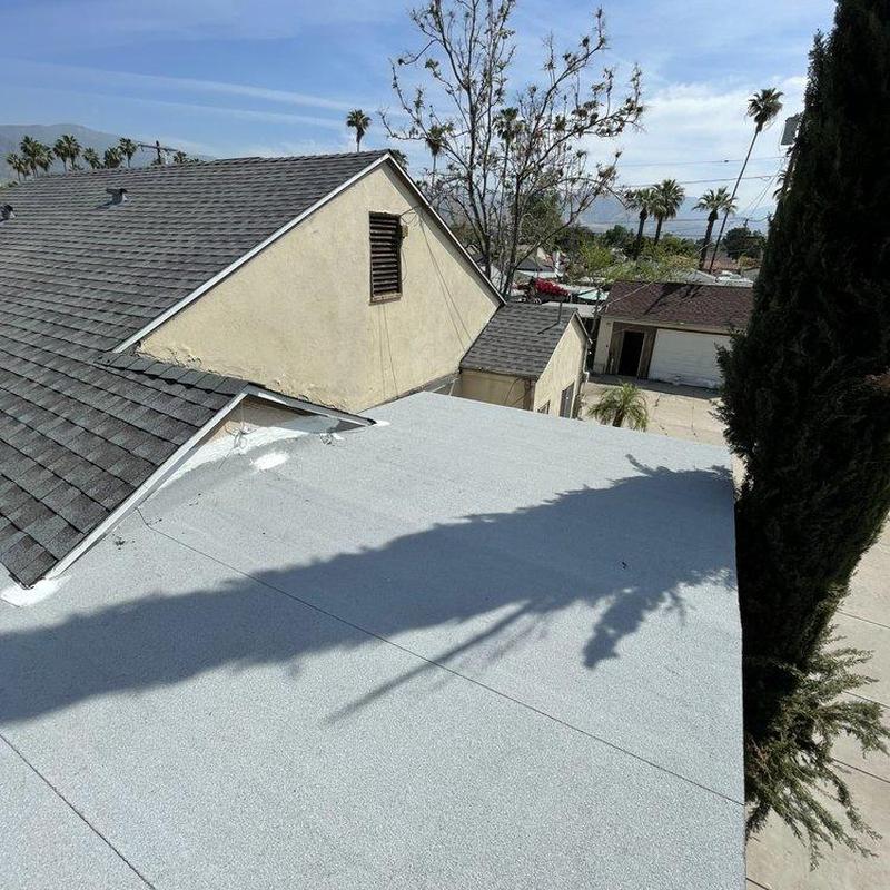 Flat roof surface inspection with adjacent shingle roof view Flat roof surface inspection with adjacent shingle roof view