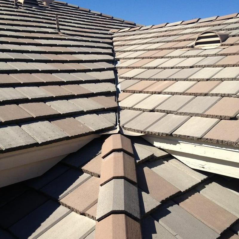 Tile roof valley and ridge cap inspection on residential roof Tile roof valley and ridge cap inspection on residential roof