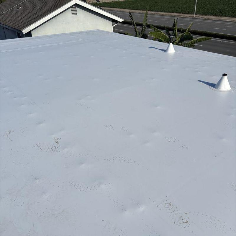 Flat roof membrane with vent pipes on residential house Flat roof membrane with vent pipes on residential house