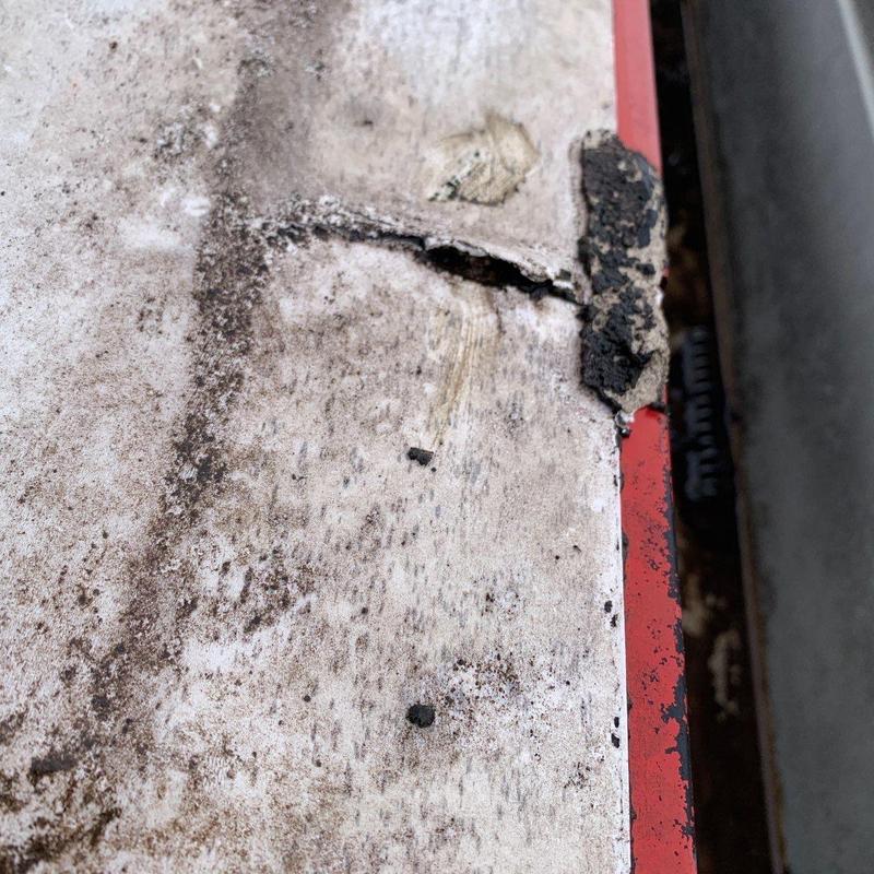 Commercial roofing membrane with hail damage and cracks